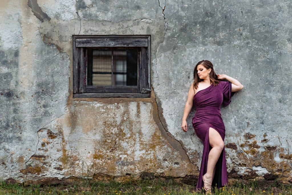 woman in her violet long dress poses for the what is glamour photography article